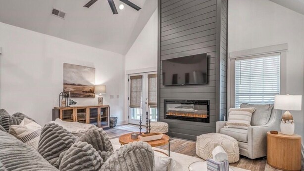 A spacious living room with a fireplace, a sofa set, and a dining area with a table and chairs. - Holiday Hills Getaway! (Counce)