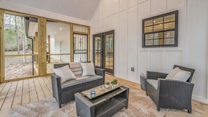 A modern living room with a sofa, two armchairs, and a coffee table. - Holiday Hills Getaway! (Counce)