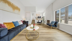 Un salon moderne avec un canapé, des fauteuils et une table basse.
