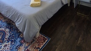 A bedroom with a bed, bedside table, lamp, and a mirror with lights. - Home in Lower Sackville (Lower Sackville)
