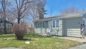 A single-story house with a front porch, a chimney, and a small front yard. - Home in Lower Sackville (Lower Sackville)