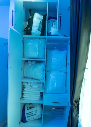 A storage compartment with neatly organized items including bags of diapers, a bottle of lotion, and a small container.