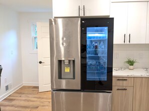 A stainless steel refrigerator with a water dispenser, a built-in ice maker, and a freezer compartment. - Retreat in countryside / Star Lake Pavillion / Golfing (Midway)