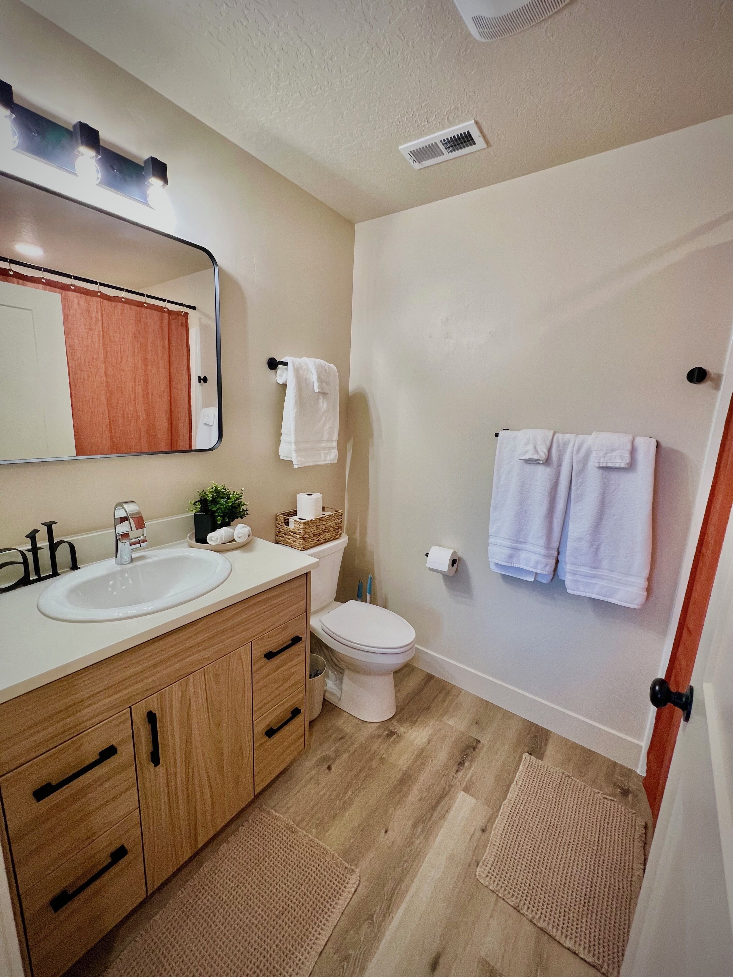 Une salle de bain avec deux lavabos, des toilettes et un espace douche.