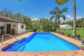 A rectangular swimming pool with a clear blue water, surrounded by a tiled deck. - 2 Bedroom 2 bath (Sarasota)