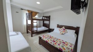 A hotel room with a bunk bed, a single bed, and a desk. - Hotel La Santamaria Montenegro Quindío (Montenegro)