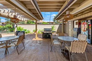 An outdoor patio with a grill, tables, and chairs. - 2bd tropical, walk to beach stay (Honokowai)