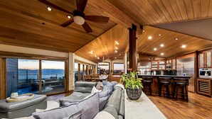 A spacious living area with a large sofa, a coffee table, and a view of the outdoors. - Tahoe Blue Estate Luxury Retreat LUXE5 (Stateline)