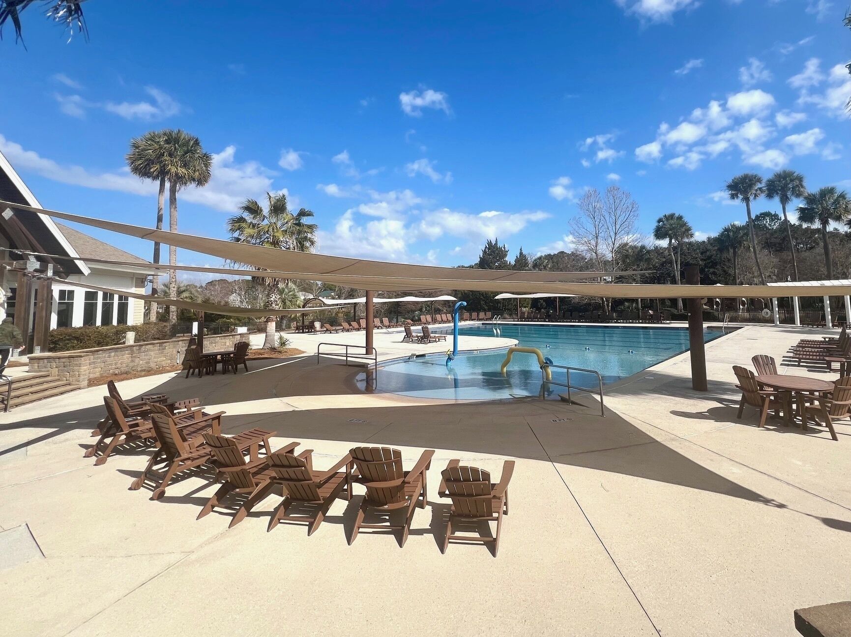 A pool area with lounge chairs and a swimming pool.