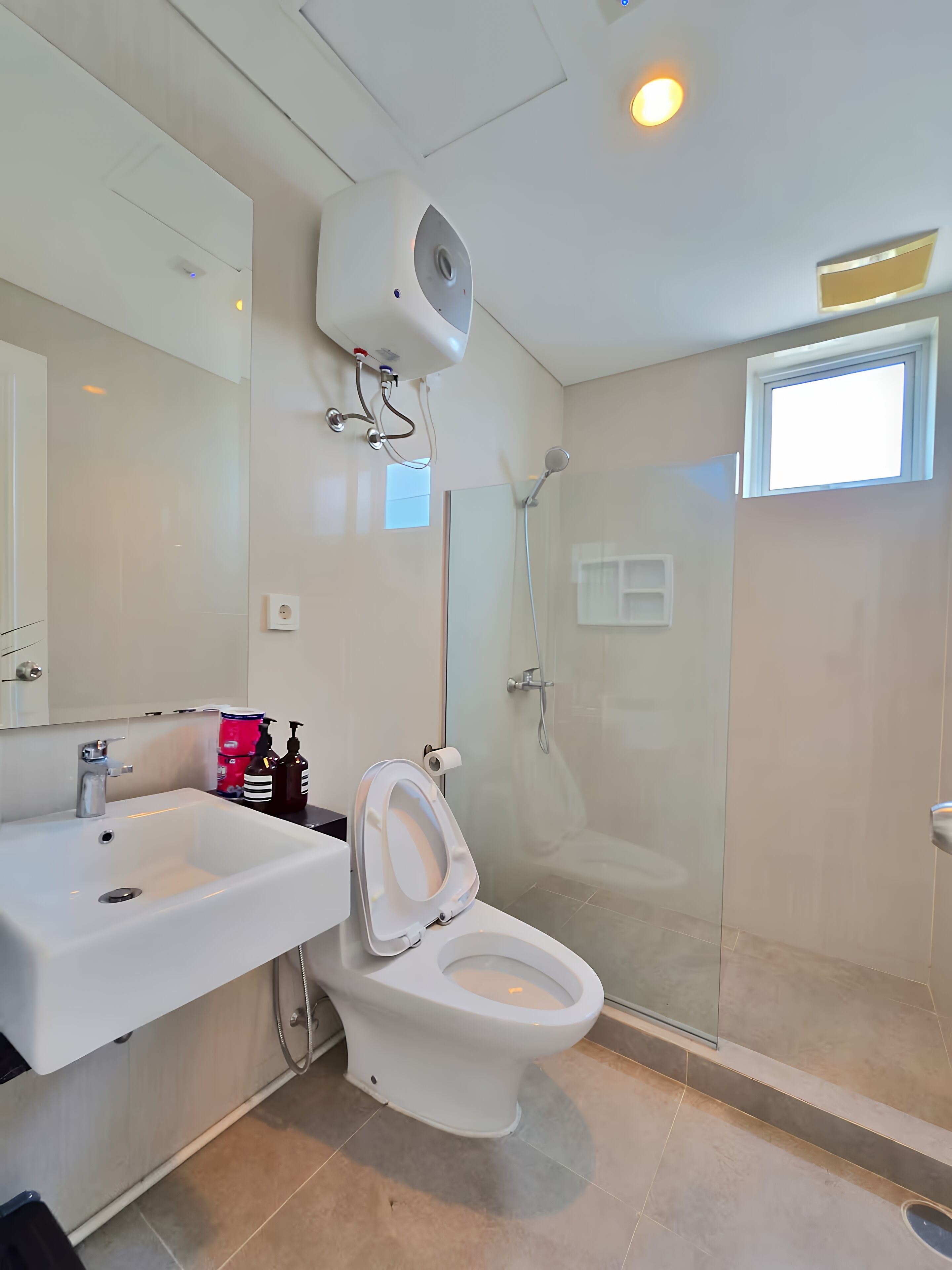 A modern bathroom with a toilet, sink, and shower.