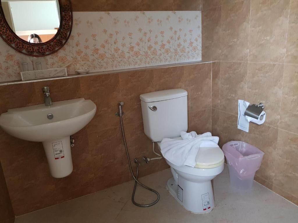 A bathroom with a sink, toilet, and shower.