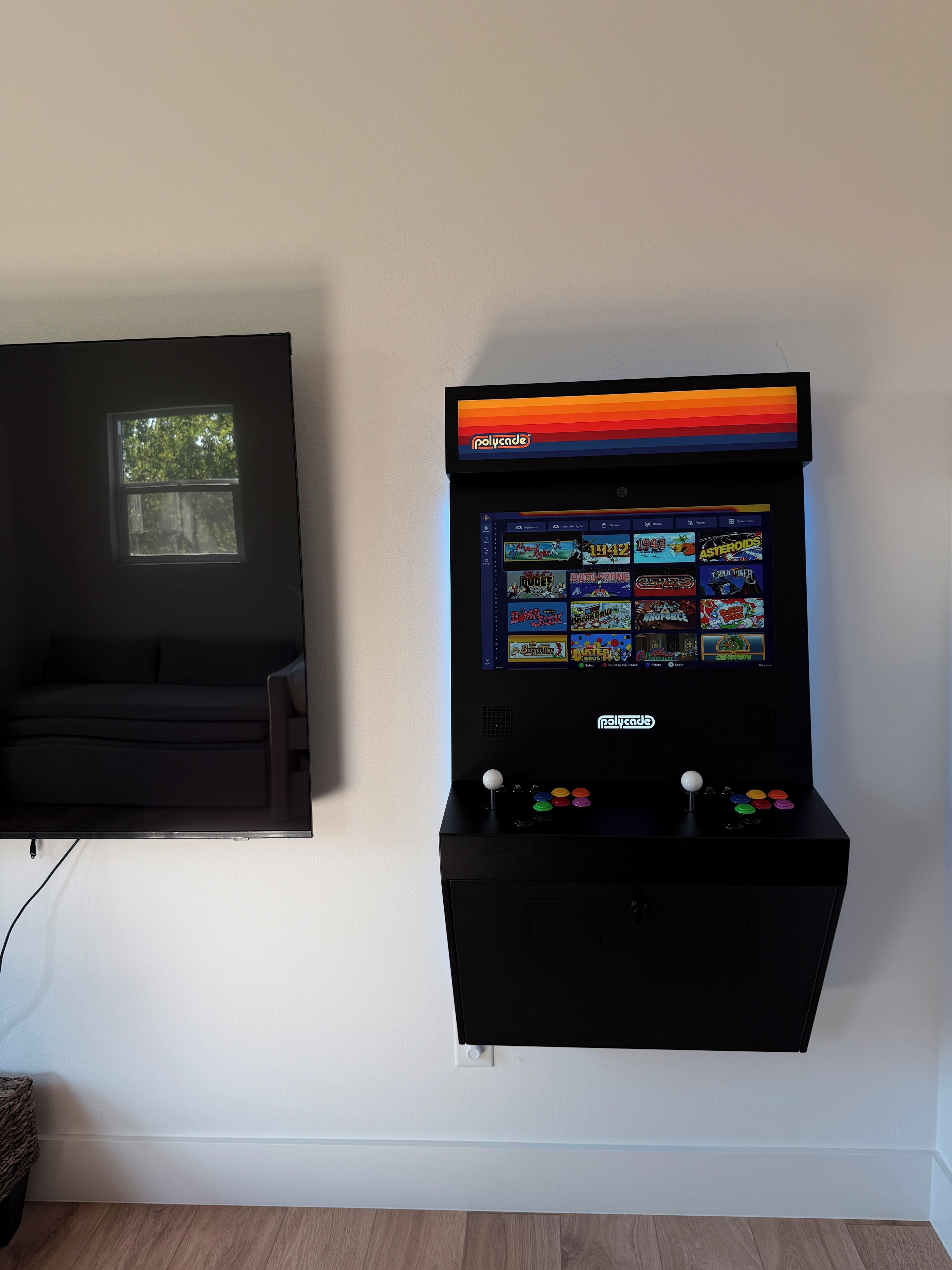 A wall-mounted arcade machine with a selection of games displayed on its screen.