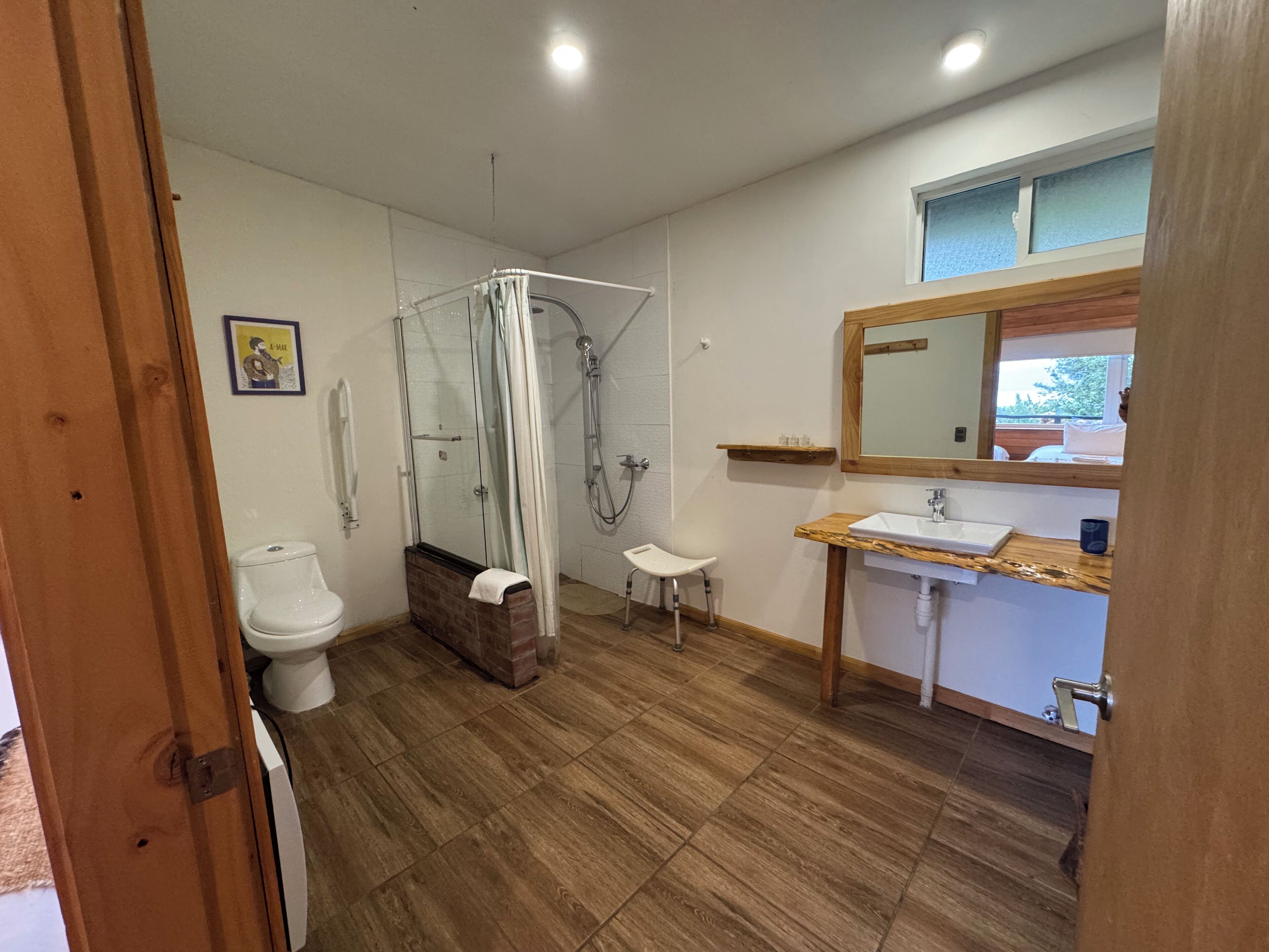 A bathroom with a shower, toilet, and sink.