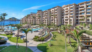 A resort with multiple buildings, a swimming pool, and palm trees. - Newly Renovated Luxury Villa! Medano Beachfront! Overlooking Pools, and Sea of Cortez! (Cabo San Lucas)
