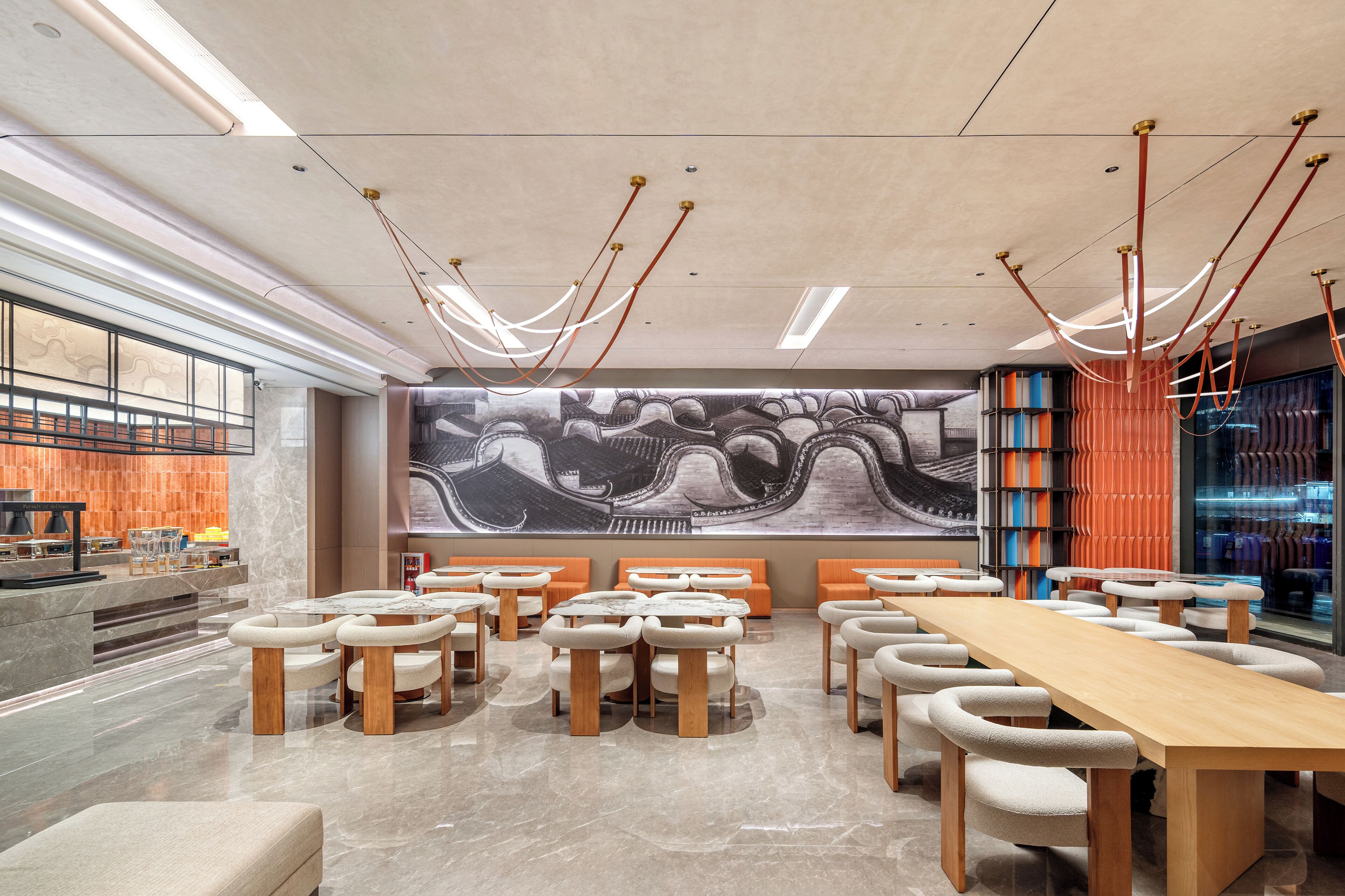 A spacious conference room with a long table and multiple chairs, a large mural on the wall, and a modern ceiling design.