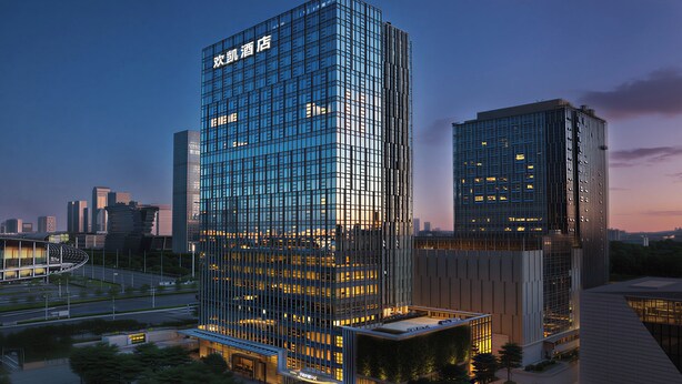 A modern high-rise hotel with a glass facade, multiple floors, and a prominent signage at the top. - From·K Hotel Pazhou (Guangzhou)