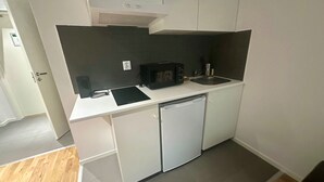 A compact kitchen with a microwave, sink, and dishwasher. - Big Studio Apartment in Sollentuna, Stockholm (Sollentuna)