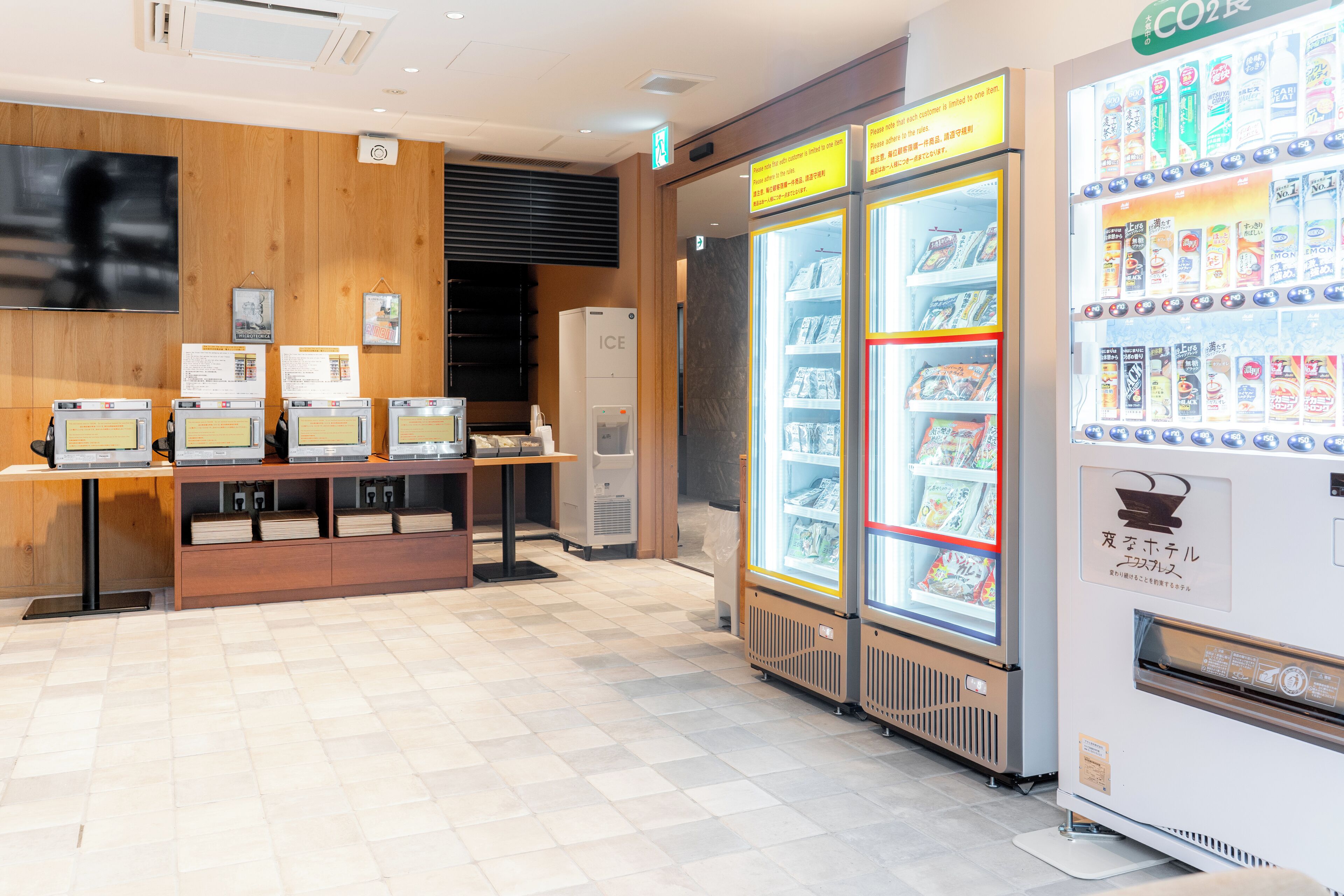 A vending machine area with a CO2 machine, a refrigerator with beverages, and a display of books and magazines.
