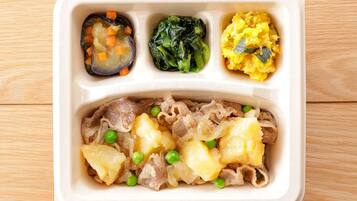 A meal in a compartmentalized container with sections for different dishes.