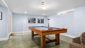 A pool table in a room with light blue walls and a wooden floor. - Gorgeous Pleasure Point Home - Sleeps 10! (Santa Cruz)