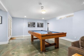 A pool table in a room with light blue walls and a wooden floor. - Gorgeous Pleasure Point Home - Sleeps 10! (Santa Cruz)