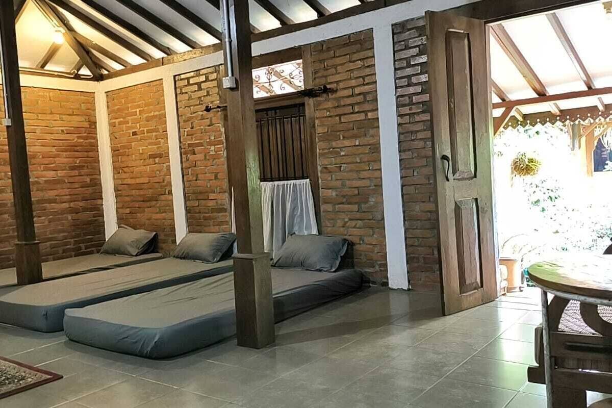 A cozy room with a brick wall, a wooden door, and a small table.