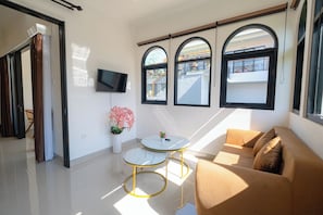 Deluxe Apartment | Living area | 32-inch LED TV with cable channels