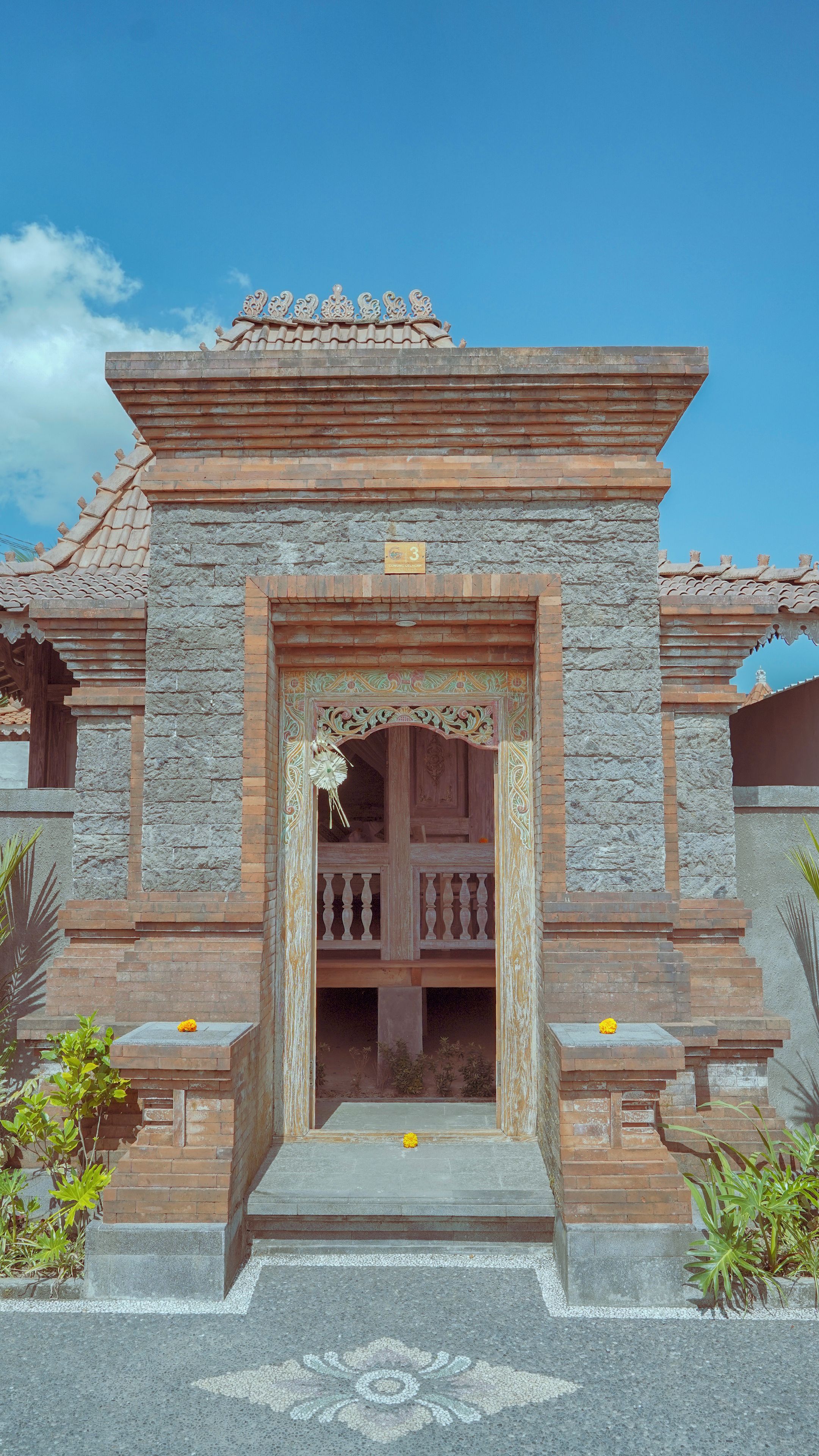 A traditional building with a stone facade, a wooden entrance, and a decorative roof.