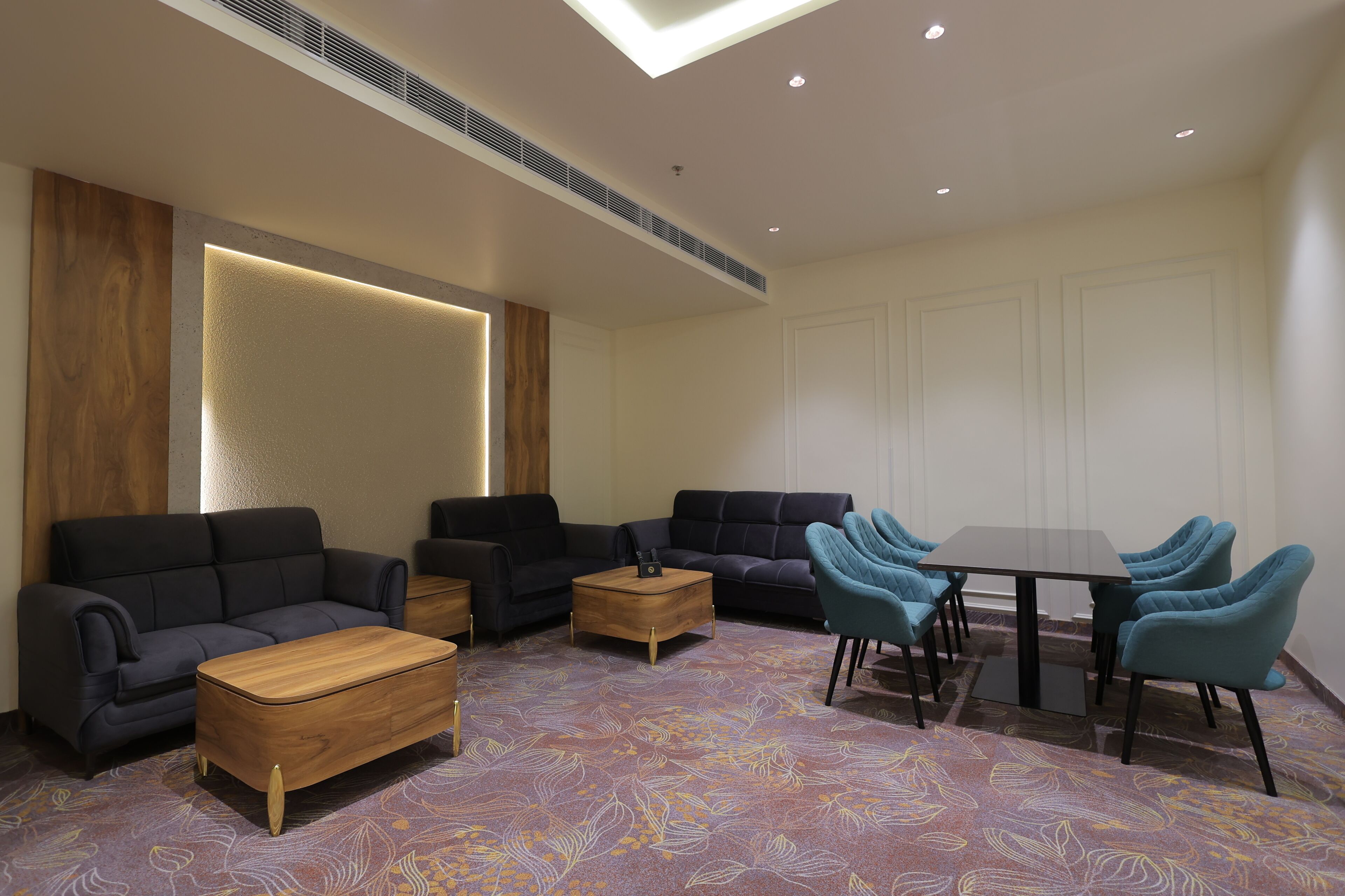 A modern lounge area with sofas, a coffee table, and a dining table with chairs.