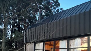 A modern building with large windows and a stone pathway leading to the entrance. - The Barn at Stonewalls - Farm stay in 25 acres In Daylesford (musk)