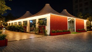 A modern building with a brick facade, large windows, and a flat roof. - OPO Horizon Surbhi Grant,Khatu Shyam (Danta Ramgarh)