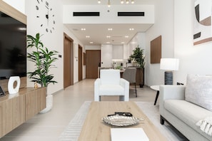 Deluxe Apartment, Balcony, City View | Living area | 55-inch Smart TV with digital channels