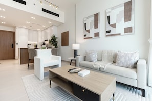 Deluxe Apartment, Balcony, City View | Living area | 55-inch Smart TV with digital channels - Binghatti Amber Residences- JVC (Dubai)