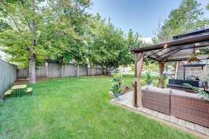 A backyard with a patio area, a table, and outdoor furniture. - 1 Mi to Dtwn Elgin: Dutch Colonial w/ Lovely Patio (Elgin)