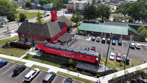 A red train station with a prominent red building and a green-roofed structure. - Unique Studio on Obanyon Creek in Dtwn Loveland! (Loveland)