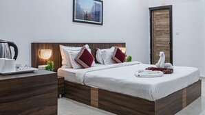 A modern bedroom with a wooden bed, white walls, and a ceiling fan.