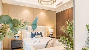 A modern hotel room with a large bed, bedside tables, and a mirror. - Spacious High-Floor 2BR with Stunning City and Burj Khalifa Views (Dubai)