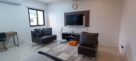 Deluxe Apartment, 1 Bedroom, Balcony, Mountain View | Living area | 50-inch Smart TV with digital channels, Netflix, streaming services