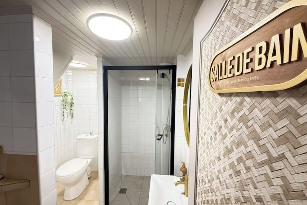 A modern bathroom with a toilet, sink, and shower area.