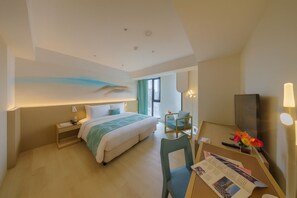 A modern hotel room with a large bed, bedside table, chair, desk with a lamp, and a TV. - Chien Tang Art Hotel (Taoyuan City)