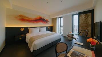 Deluxe Room | Down comforters, individually decorated, desk, laptop workspace