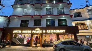 A multi-story building with a sign for "Hotel Kuber Palace N Restaurant." - Hotel Kuber Palace Badrinath (Badrinath)