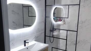 Shower, towels, soap, toilet paper