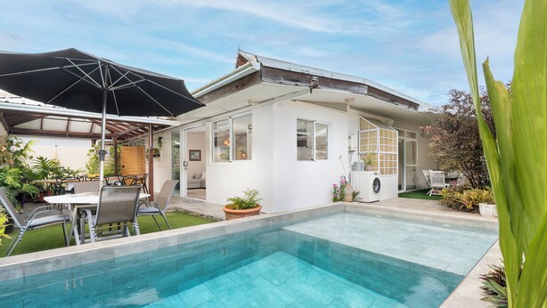 A modern house with a swimming pool, a patio with outdoor furniture, and a garden area. - Modern Guesthouse with Private Pool • Close to Beaches, Shops & Restaurants • (Punaauia)