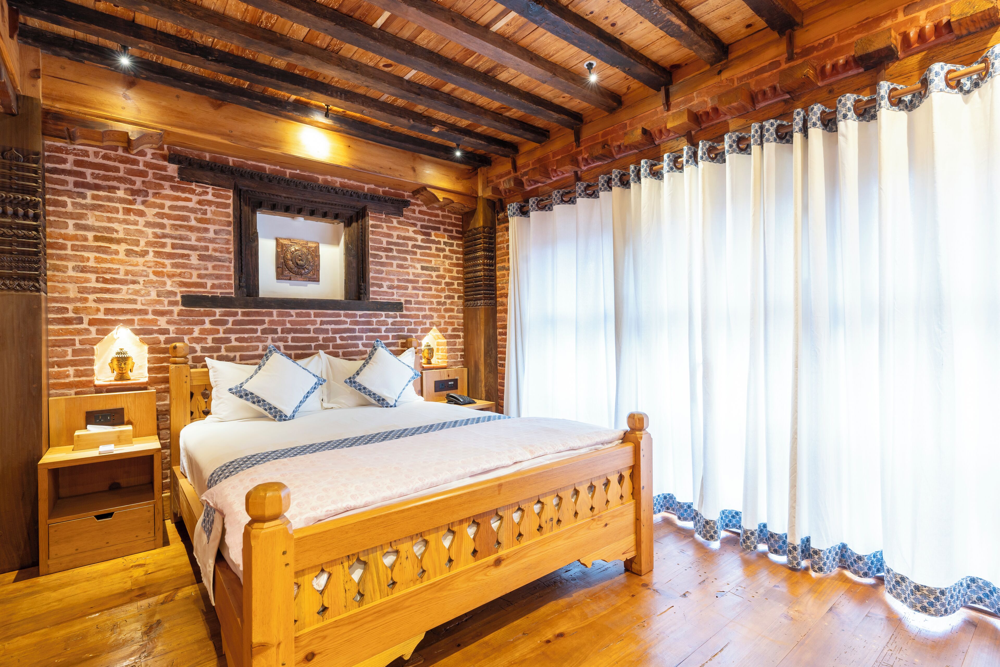 A wooden bed with a headboard, a nightstand, a wall-mounted clock, and a window with curtains.