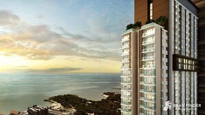 A high-rise building with multiple floors, large windows, and a view of the sea. - Sea View High Floor 2 Bed Room-Excellent Location (Pattaya City)