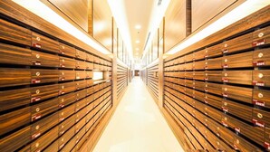 A long, narrow hallway with wooden paneling on both sides and a bright, well-lit ceiling. - Sea View High Floor 2 Bed Room-Excellent Location (Pattaya City)