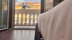 A room with a large window, a bed, and a view of a construction site. - Naples Plaza Duomo (Naples)