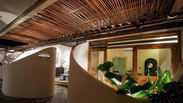 A modern interior with curved walls and a wooden ceiling.