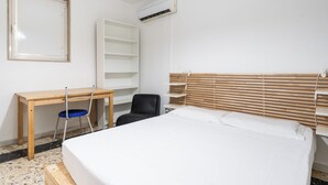 A bedroom with a bed, a desk, a chair, and a wardrobe. - Casina del Parco by Wonderful Italy (Bari)